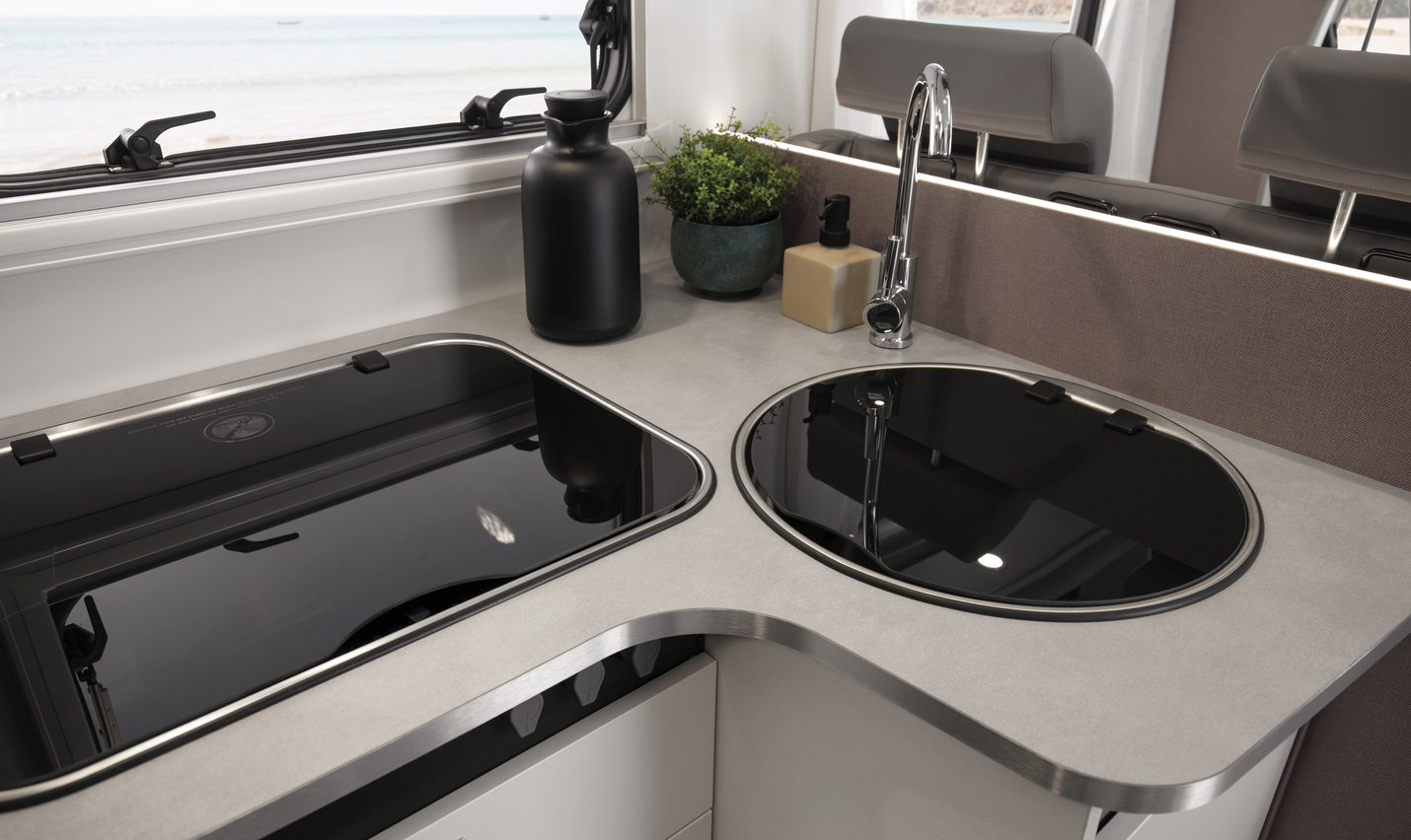 Detail of the fully equipped kitchenette in the Etrusco semi-integrated motorhome on a Ford base, perfect for camping and road trips.